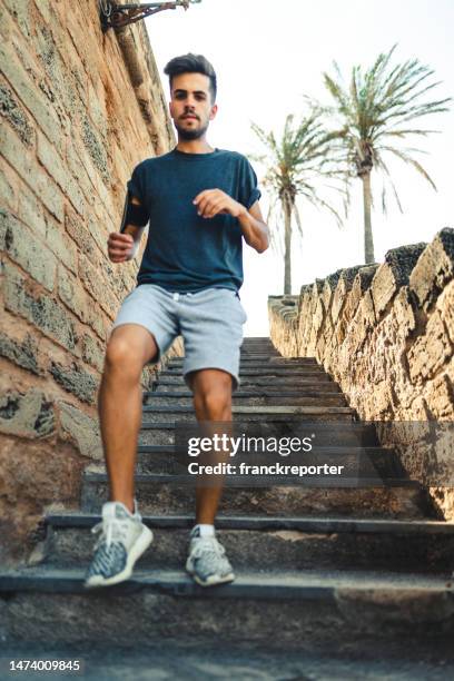 sport man descending the stairs - low motivation stock pictures, royalty-free photos & images