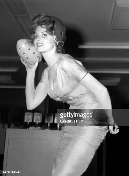 American actress Tina Louise poses for a portrait kicking a wiffle ball as she lends her support to help promote sporting goods sales in New York,...