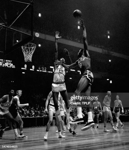 Bill Russell of the Boston Celtics takes the hook shot over Wilt Chamberlain of the Philadelphia Warriors as Woody Sauldsberry and Paul Arizin of the...