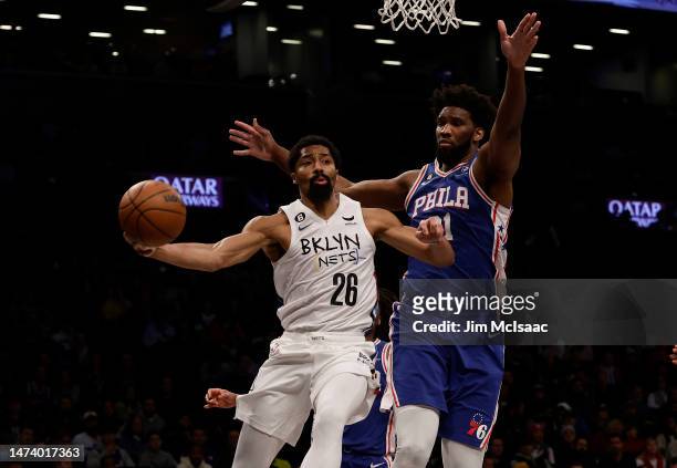 Spencer Dinwiddie of the Brooklyn Nets in action against Joel Embiid of the Philadelphia 76ers at Barclays Center on February 11, 2023 in New York...