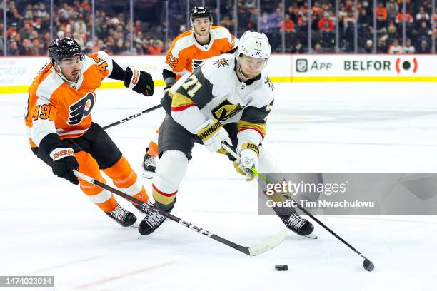 Noah Cates of the Philadelphia Flyers and William Karlsson of the Vegas Golden Knights challenge for the puck at Wells Fargo Center on March 14, 2023...