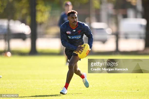 Kysaiah Pickett of the Demons runs with the ball during a Melbourne Demons AFL training session at Gosch's Paddock on March 17, 2023 in Melbourne,...