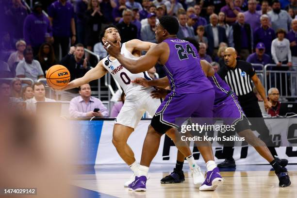 Kihei Clark of the Virginia Cavaliers passes the ball as time expires in the second half against the Furman Paladins in the first round of the NCAA...