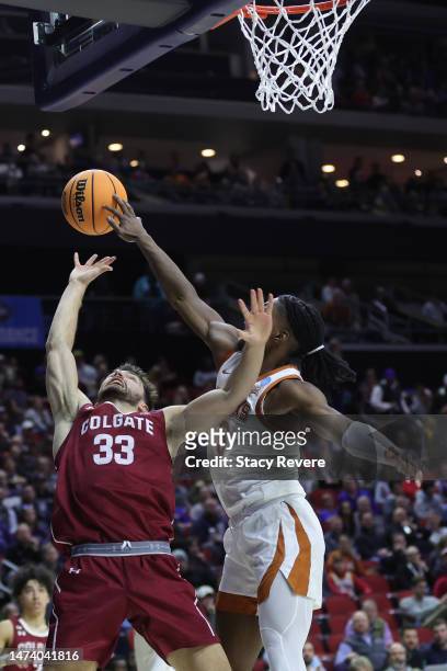 Marcus Carr of the Texas Longhorns blocks a shot by Oliver Lynch-Daniels of the Colgate Raiders during the second half in the first round of the NCAA...