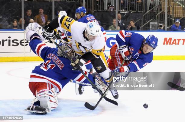 Igor Shesterkin and Vladimir Tarasenko of the New York Rangers combine to stop Sidney Crosby of the Pittsburgh Penguins during the third period at...