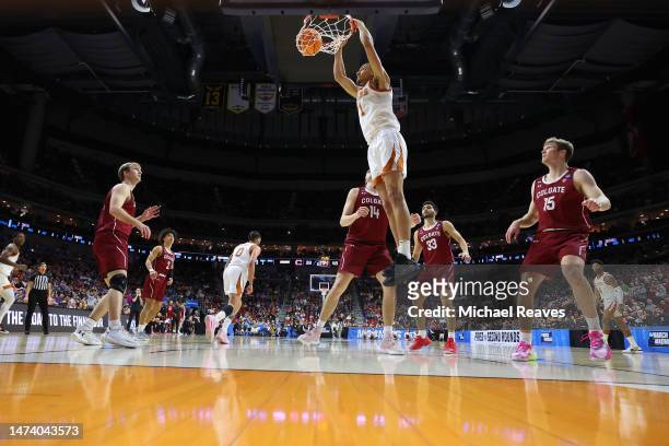 Dylan Disu of the Texas Longhorns dunks the ball in front of Keegan Records of the Colgate Raiders during the second half in the first round of the...