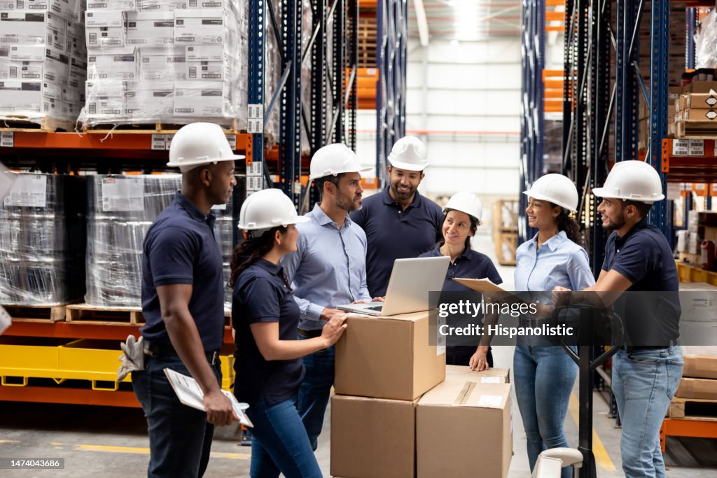 Business manager talking to a group of employees at a distribution warehouse