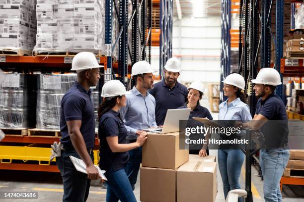 business manager talking to a group of employees at a distribution warehouse - a meeting place for the european digital industry stock pictures, royalty-free photos & images