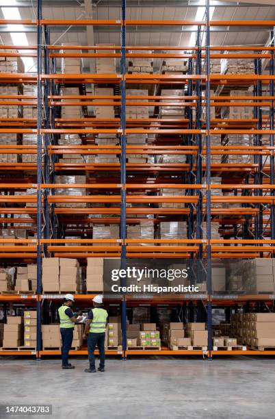 men working at a distribution warehouse - distribution warehouse stock pictures, royalty-free photos & images