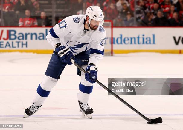 Alex Killorn of the Tampa Bay Lightning takes the puck and scores the game winner during the shootout against the New Jersey Devils at Prudential...
