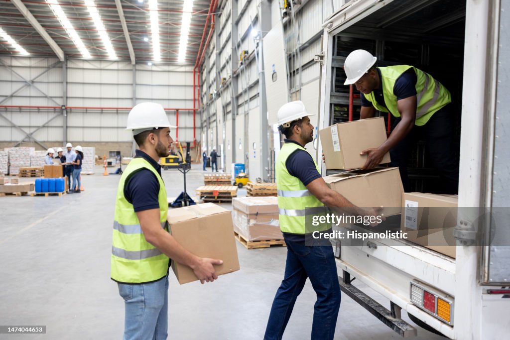 Workers at a distribution warehouse loading boxes on a truck