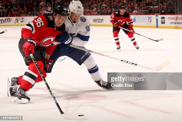 Timo Meier of the New Jersey Devils heads for the net as Mikhail Sergachev of the Tampa Bay Lightning defends during the overtime period at...