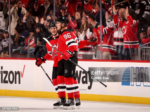 Timo Meier of the New Jersey Devils is congratulated by teammate Dawson Mercer after Meier scored in the third period against the Tampa Bay Lightning...