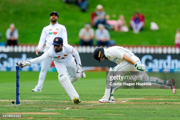 Tom Latham of New Zealand makes his ground as Nishan Fernando of Sri Lanka removes the bails during day one of the Second Test Match between New...