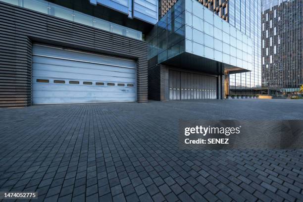empty square by modern architectures - industrial doors stock pictures, royalty-free photos & images