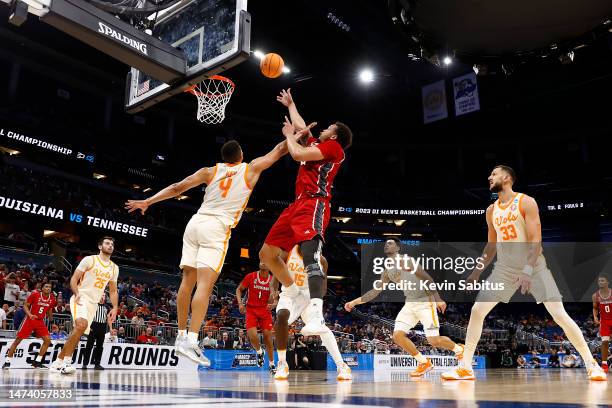 Kobe Julien of the Louisiana Lafayette Ragin Cajuns attempts to shoot against Tyreke Key of the Tennessee Volunteers during the second half in the...