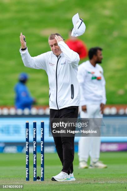 Umpire Chris Gaffaney has his hat blown off by strong winds during day one of the Second Test Match between New Zealand and Sri Lanka at Basin...