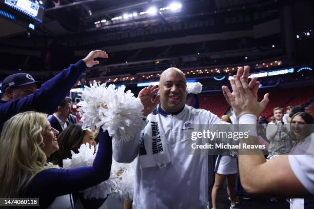 Head coach Micah Shrewsberry of the Penn State Nittany Lions celebrates with the cheerleading team after defeating the Texas A&M Aggies 76-59 in the...