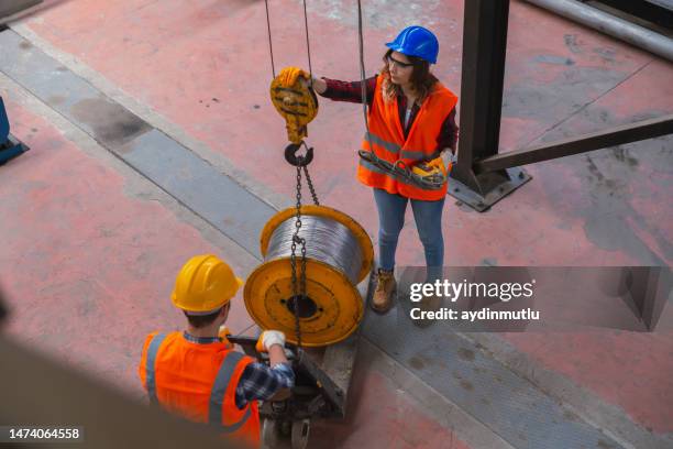 young industry employees holding and working with remote control for operating crane - load lifter stock pictures, royalty-free photos & images
