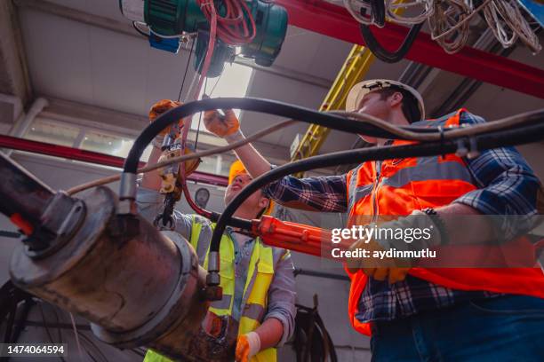 industrial machinery male employees working with remote control for operating crane - hydraulisch platform stockfoto's en -beelden