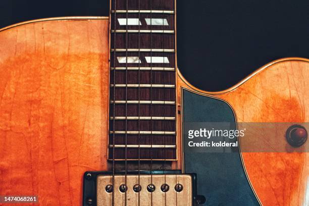 closeup of vintage electric guitar on black background - fretboard stock pictures, royalty-free photos & images