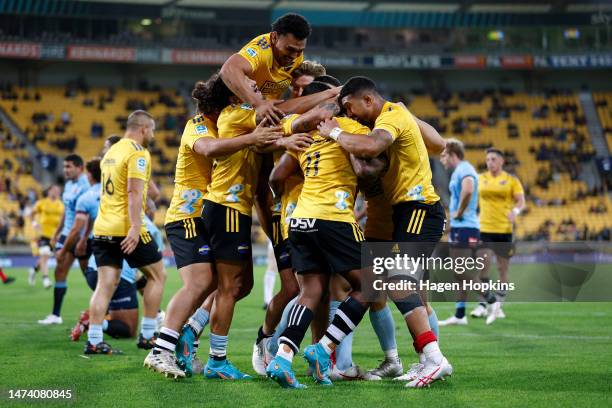 Kini Naholo of the Hurricanes celebrates with teammates after scoring a try during the round four Super Rugby Pacific match between Hurricanes and...