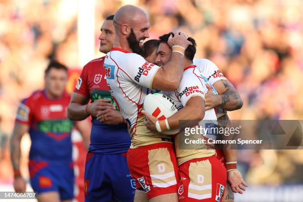 Kodi Nikorima of the Dolphins celebrates with team mates after scoring a try during the round three NRL match between Newcastle Knights and Dolphins...