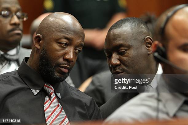 Tracy Martin, father of Trayvon Martin, confers with his attorney Benjamin Crump during the bond hearing for George Zimmerman on June 29, 2012 in...