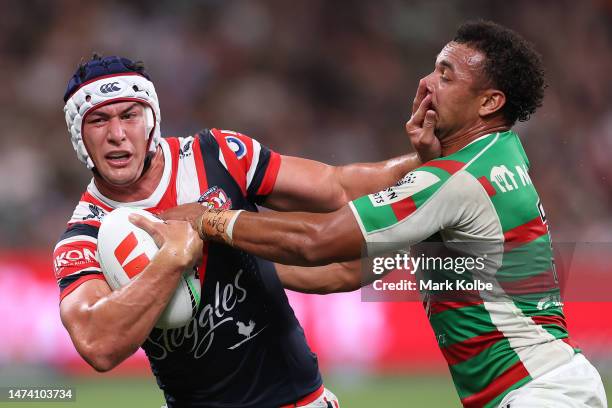 Joseph Manu of the Roosters is tackled by Isaiah Tass of the Rabbitohs during the round three NRL match between Sydney Roosters and South Sydney...