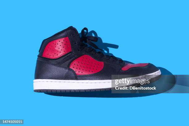 black and red basketball sneakers, on a blue background. concept for sneaker, basketball, retro, fashion, collection and casual - black shoe ストックフォトと画像