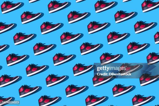 pattern of black and red basketball sneakers, on a blue background. concept for sneaker, basketball, retro, fashion, collection and casual - pair stock photos et images de collection