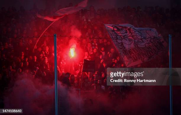 Supporters of Zwickau set off pyrotechnics during the 3. Liga match between FSV Zwickau and Erzgebirge Aue at GGZ Arena on March 14, 2023 in Zwickau,...