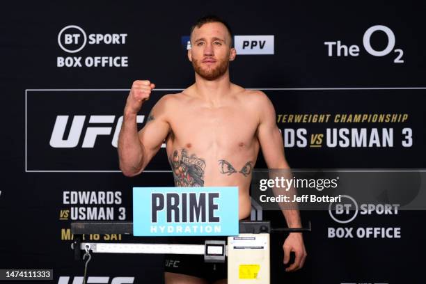 Justin Gaethje poses on the scale during the UFC 286 official weigh-in at Hilton London Canary Wharf on March 17, 2023 in London, England.