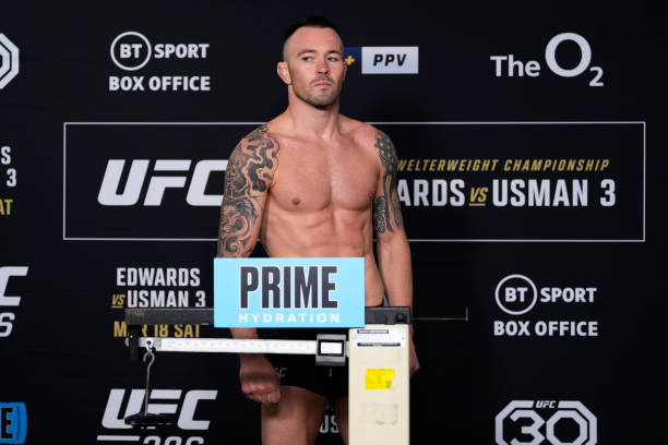 Colby Covington poses on the scale during the UFC 286 official weigh-in at Hilton London Canary Wharf on March 17, 2023 in London, England.
