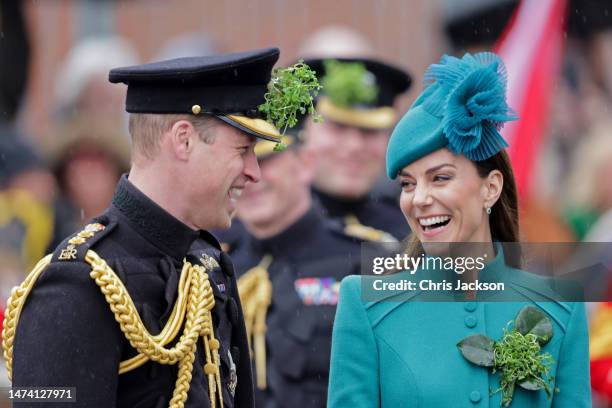 Prince William, Prince of Wales and Catherine, Princess of Wales laughing during the St. Patrick's Day Parade at Mons Barracks on March 17, 2023 in...