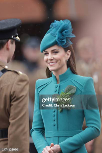 Catherine, Princess of Wales presents a traditional sprig of shamrock to an Officer during the St. Patrick's Day Parade at Mons Barracks on March 17,...