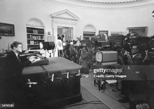 President John F. Kennedy speaks during a televised speech to the nation about the strategic blockade of Cuba, and his warning to the Soviet Union...