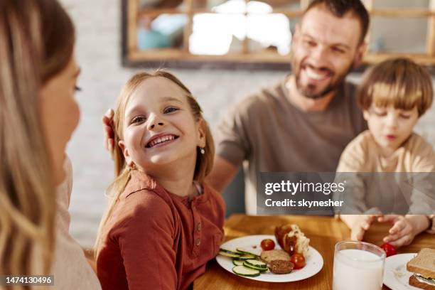 happy girl enjoying during family's breakfast at home. - family at dining table stock pictures, royalty-free photos & images