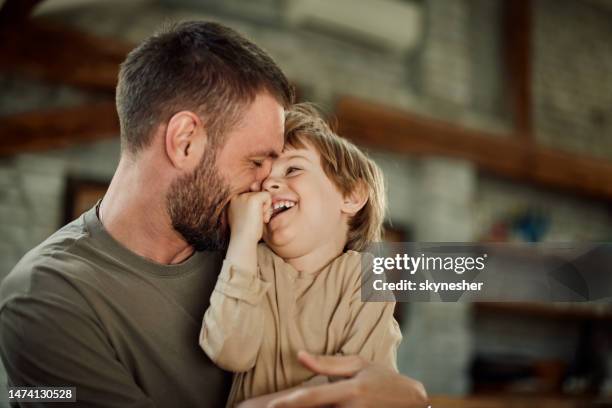 ragazzo felice che si diverte con il suo padre single a casa. - embracing foto e immagini stock