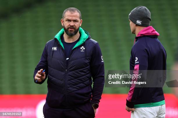 Johnny Sexton the Ireland captain talks to head coach Andy Farrell during the Ireland captain's run at the Aviva Stadium on March 17, 2023 in Dublin,...