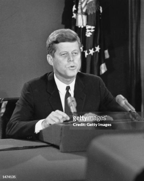 President John F. Kennedy speaks during a televised speech to the nation about the strategic blockade of Cuba and his warning to the Soviet Union...