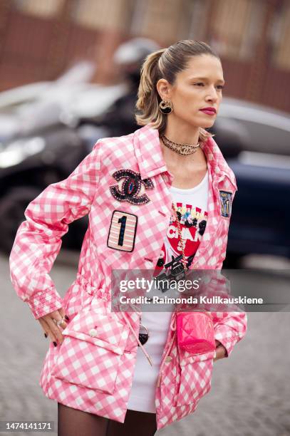 Helena Bordon seen wearing a pink and white patterned jacket, a white skirt, a printed shirt, black transparent tights, a pink bag, a choker and...