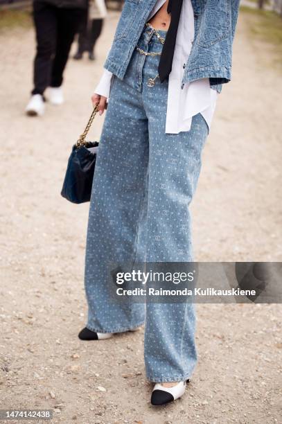 Alizee Gamberini seen wearing a denim look with a west and oversized jeans, a white oversized blouse, white and black shoes, a black tie, black...