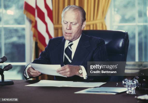 President Gerald Ford signs a document granting former President Richard Nixon a full pardon, at the White House in Washington on September 8th, 1974.