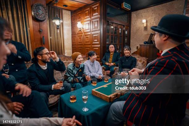 magician performing a small magic show at a restaurant - large dinner party stock pictures, royalty-free photos & images