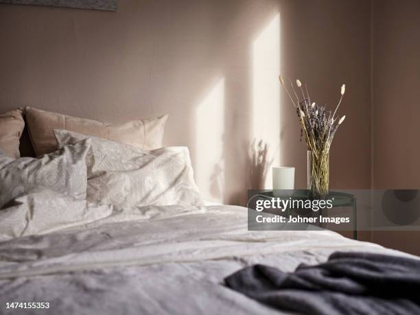 view of bed in bedroom - side table stock pictures, royalty-free photos & images