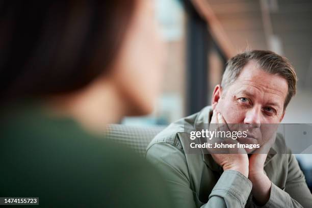 man holding head in hands - alternative therapy stock pictures, royalty-free photos & images