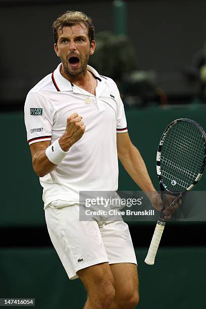 Julien Benneteau of France celebrates set point during his Gentlemen's Singles third round match against Roger Federer of Switzerland on day five of...