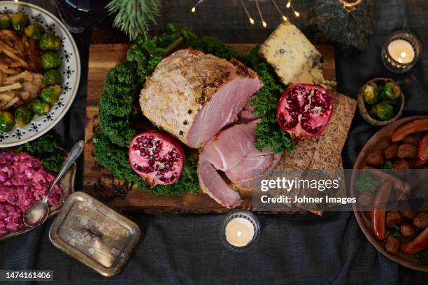 christmas food and decoration on table - vleesgerecht stockfoto's en -beelden