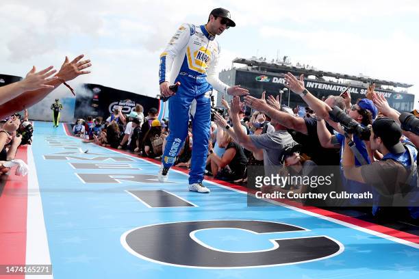 Chase Elliott, driver of the NAPA Auto Parts Chevrolet, greets fans as he walks onstage during driver intros prior to the NASCAR Cup Series 65th...